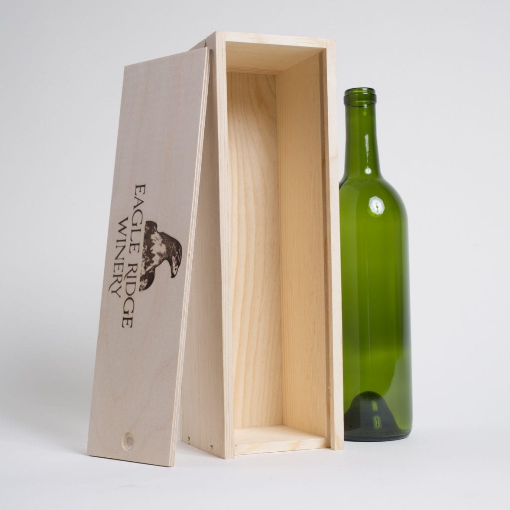 1 Bottle Pinewood box with vertical sliding lid. USA sourced, FSC Certified Pinewood. Thickness 3/4". Birch plywood Lid. Staples assembly. Printing: One (1 color) silkscreen or fire branding on Lid INSIDE DIMENSIONS: 12-1/4"L x 3-3/8" W X 3-3/8" H OUTSIDE DIMENSIONS: 13"L x 4" W x 4-1/4" H
