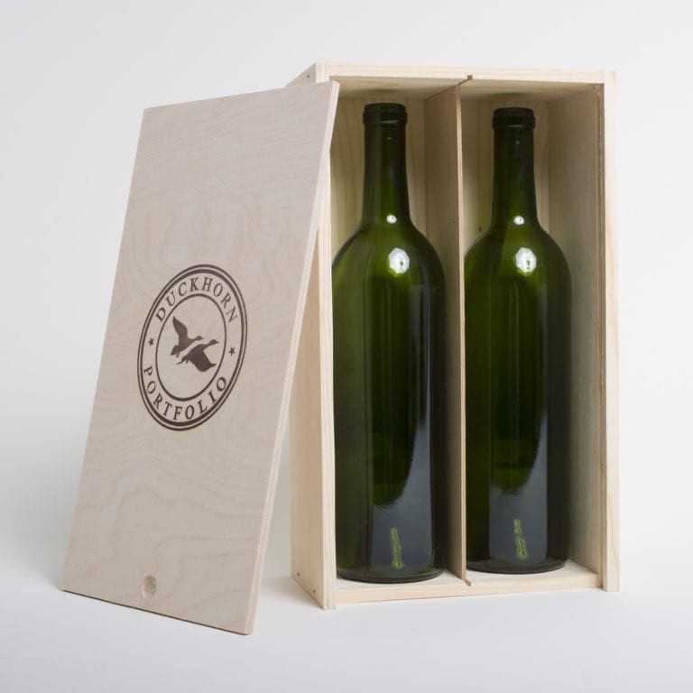 2 Bottle Pinewood box with vertical sliding lid and mobile plywood dividers. USA sourced, FSC Certified Pinewood. Thickness 3/4". Birch plywood Lid and dividers . Staples assembly. Printing: One ( 1 color ) silkscreen) orfire branding on Lid INSIDE DIMENSIONS: 12-1/4" L X 6-7/8" W X 3-3/8" H OUTSIDE DIMENSIONS: 13" L X 7-1/2" W X 4-1/4" H